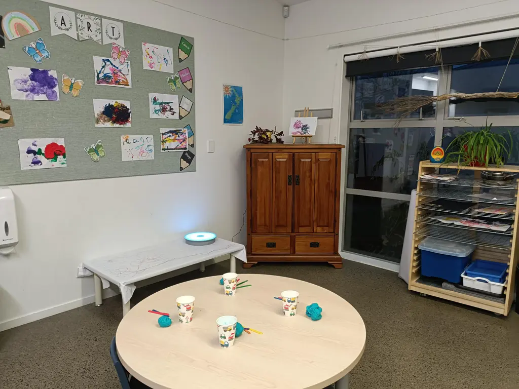 Harmony Haven wall display showing children's artwork and learning